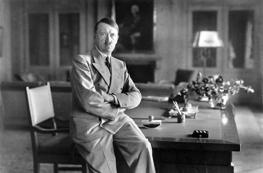 Adolf Hitler Sitting On A Table