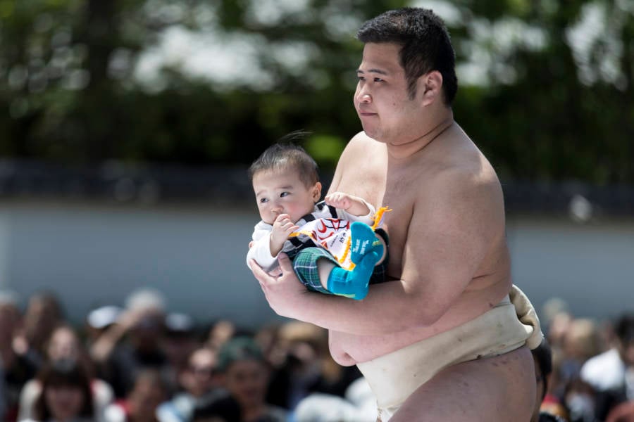 In japan letting a sumo wrestler make your baby cry is considered good ...