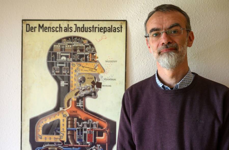Andreas Winkelmann In Front Of Anatomy Poster