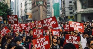 Protestors With Stop Killing Us Signs