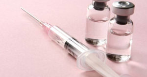 Syringe Beside Bottles