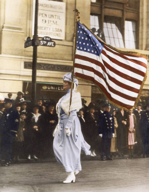 Color Woman In White Marches With American Flag