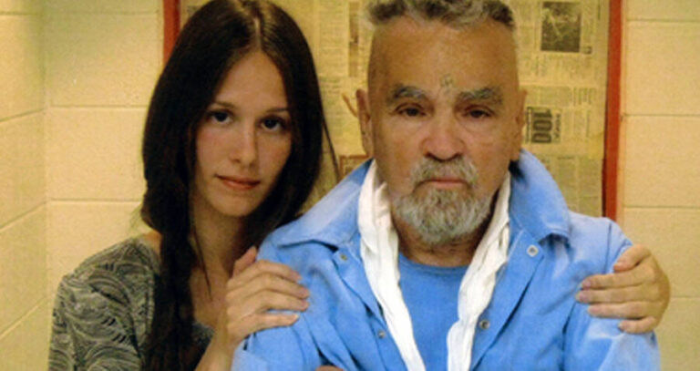 Afton Burton Holds Mansons Shoulders