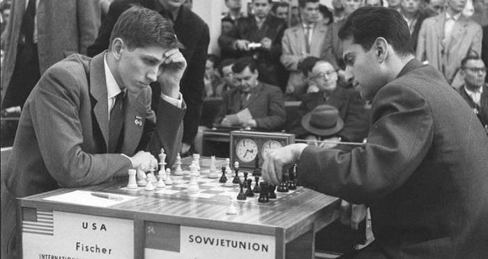 Chess champion Bobby Fischer working on his moves during a subway