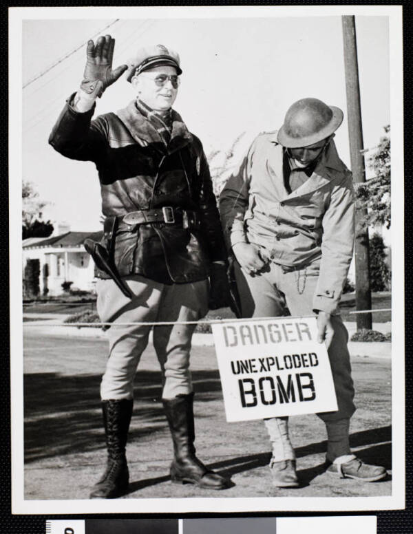 Army Officers With A Danger Unexploded Bomb Sign