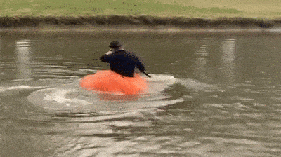 Man Paddling His Pumpkin Boat