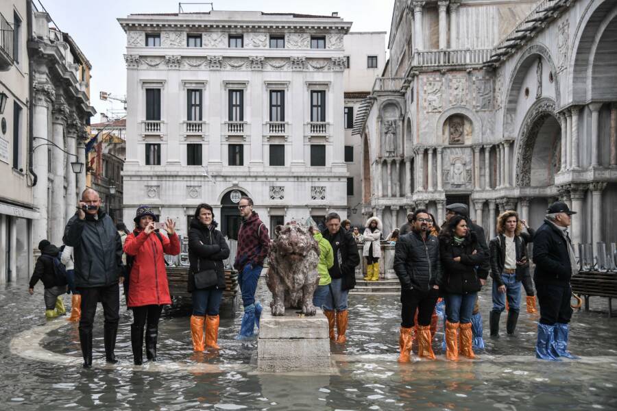 Tourists Waiting In Venice Flood