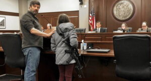 Bailey Nielsen Holding A Rifle