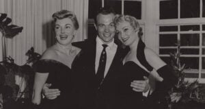 Bowers With His Arms Around Two Women