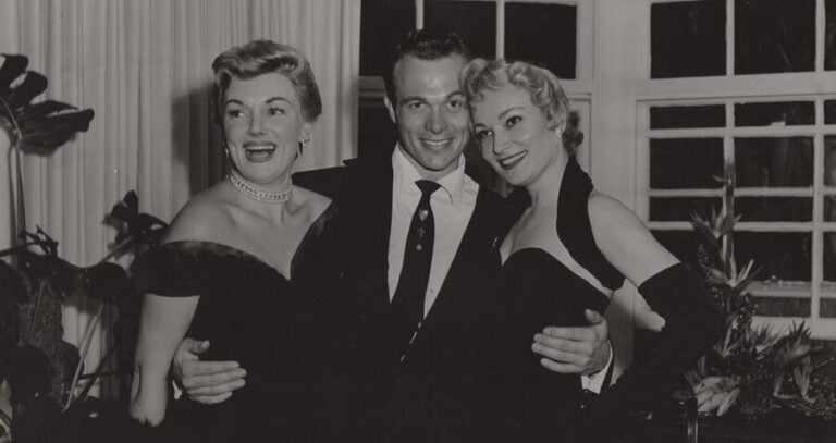 Bowers With His Arms Around Two Women