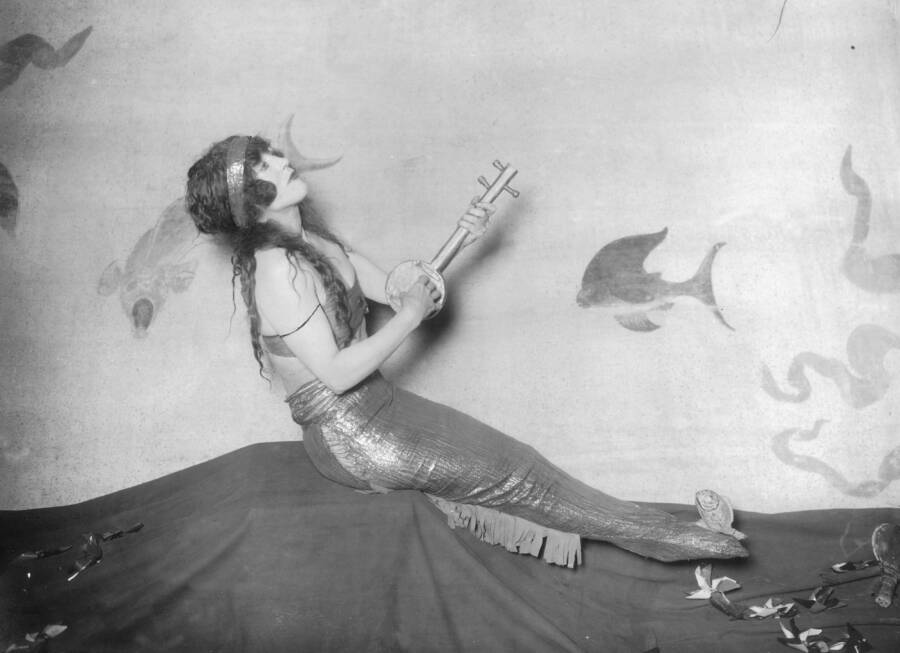 Kellerman Dressed As A Mermaid Playing Guitar