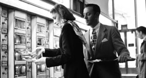 Couple Using An Automat Featured