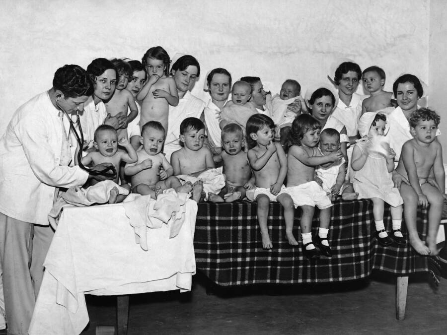 Babies And Nurses Gathered Around Babies