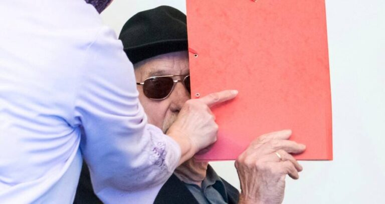 Bruno Dey Peaking Out From Behind A Folder