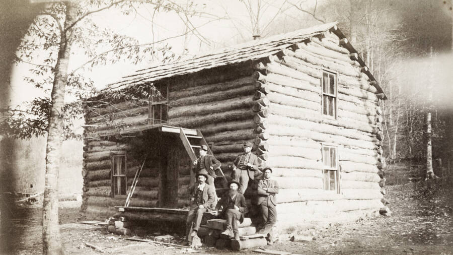 Hatfields In Front Of Log Cabin