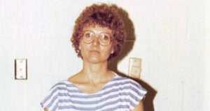 Candy Montgomery Standing Against White Wall