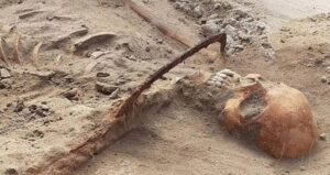 Vampire Skeleton With Sickle Across Its Neck