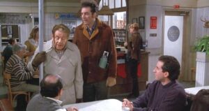 Frank Costanza With Festivus Pole In Restaurant
