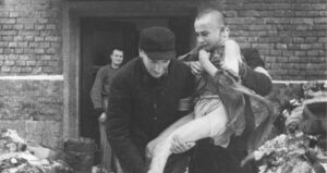 Soviet Soldier Carrying A Starving Teen From Auschwitz