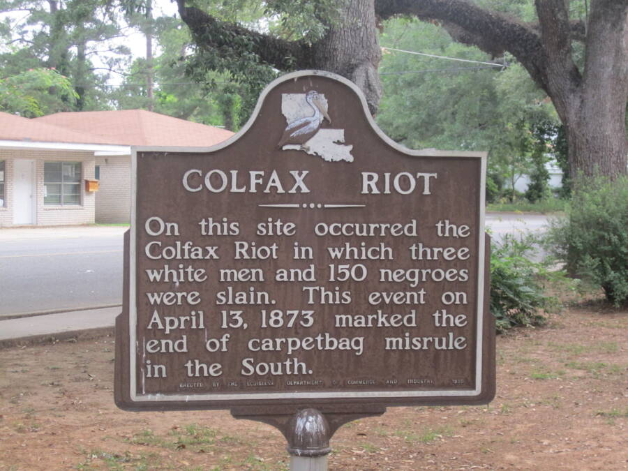 Colfax Riot Historic Marker reads "On this site occurred the Colfax Riot in which three white men and 150 negroes were slain. This event on April 13, 1873 marked the end of carpetbag misrule in the South."