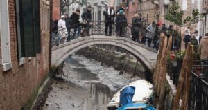 Tourists On Bridge In Venice