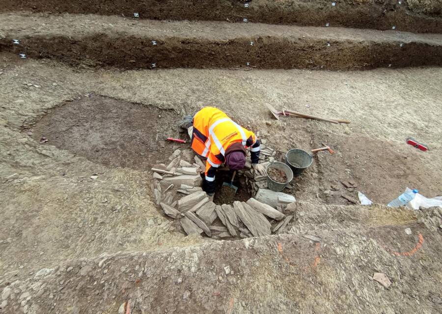 Archaeologist cleaning a well