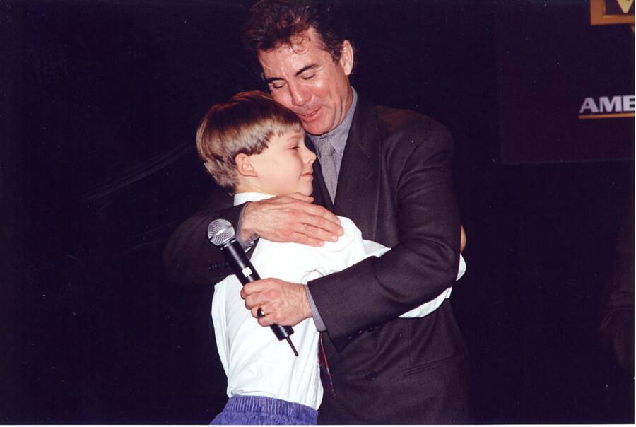 John Walsh Hugging A Child