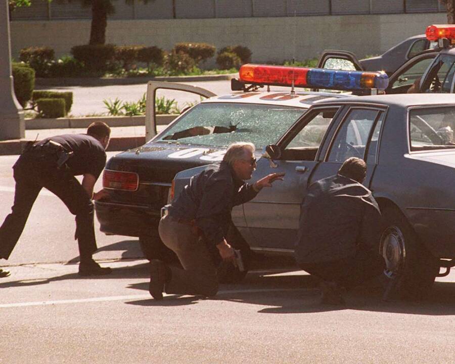 Officers Crouching Behind A Car