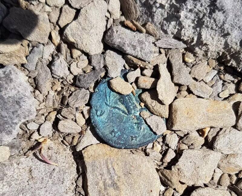 Roman Coin Near Shrine In Swiss Alps