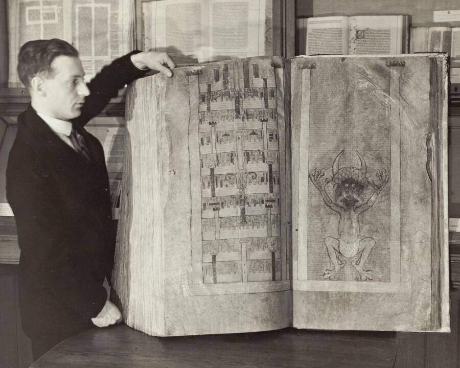 Man Standing Next To The Devil's Bible
