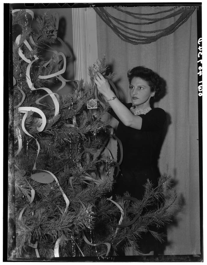 Woman Decorating A Tree