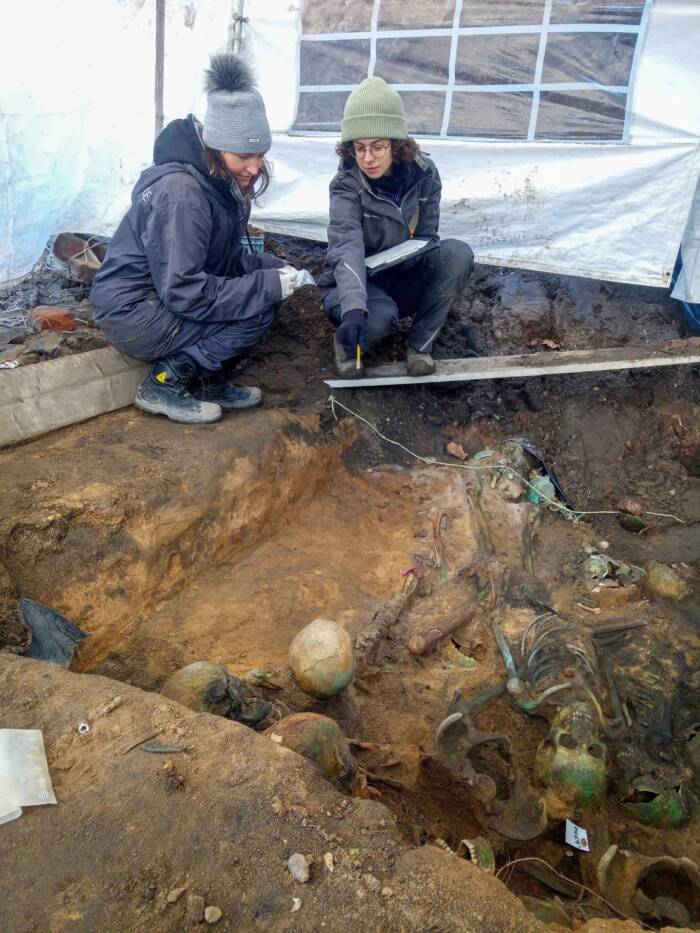 Archaeologists At Mass Grave