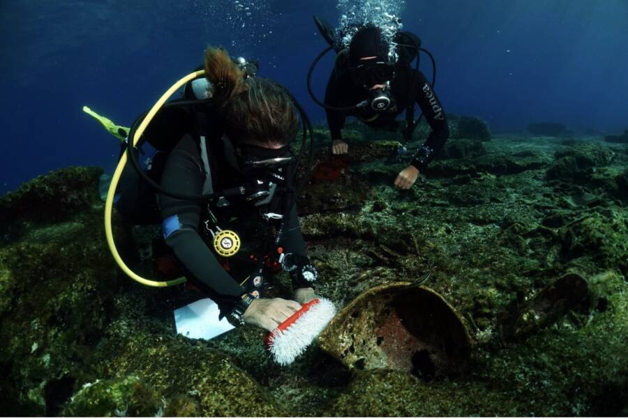 Divers Examining Artifacts Near Greece