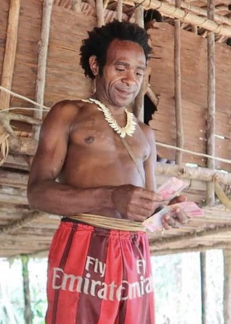 Korowai Man Counting Money