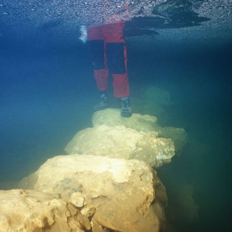 Man Standing On A Submerged Bridge