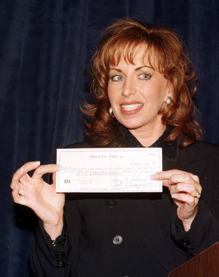 Paula Jones Holding A Check