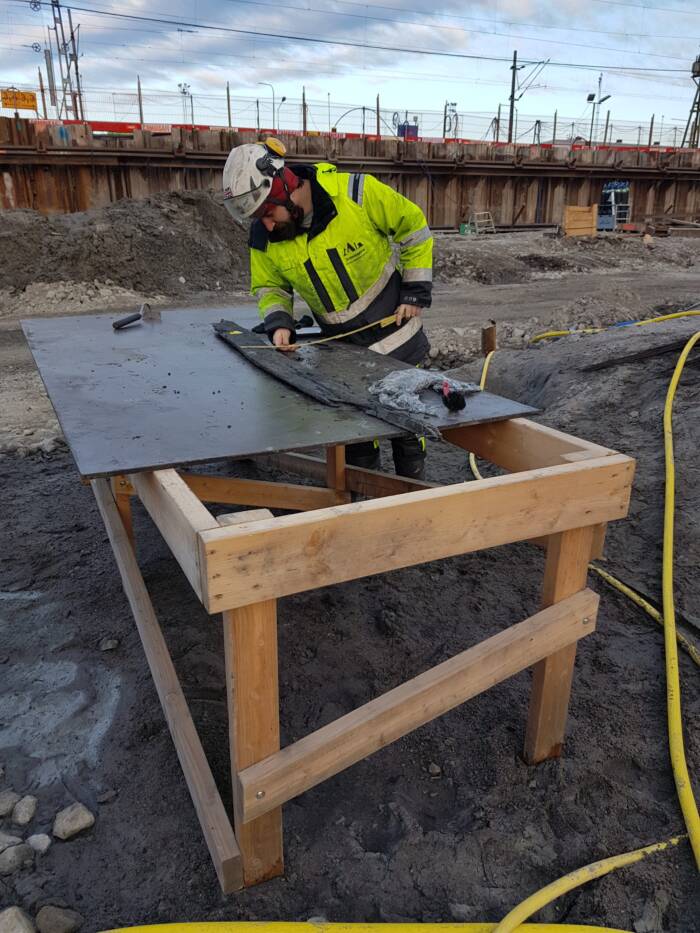 Archaeologist Examining Timber