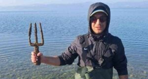 Osman Erim Holding The Trident Featured