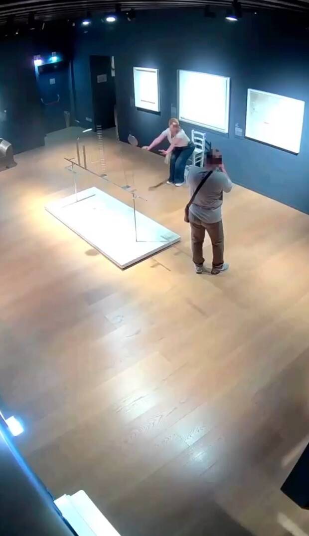 Couple Taking Photos With Van Gogh Chair
