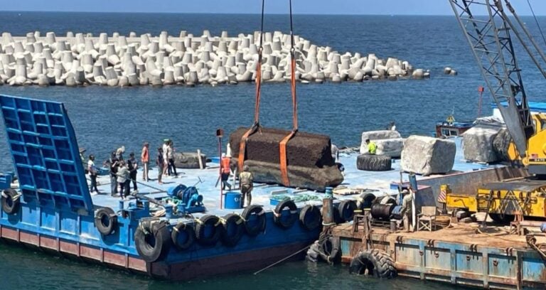 Crane Lifting Stone Block Featured