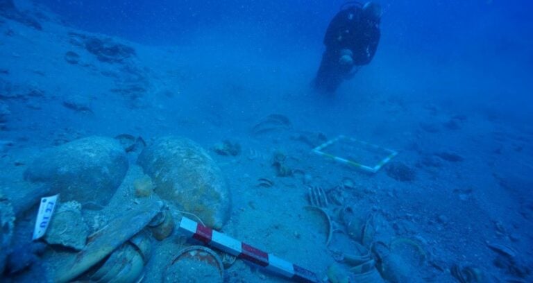 Diver Looks At Underwater Ceramic Artifacts Featured