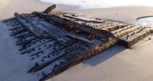 Shipwreck On Beach Featured
