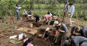 Students Working At Excavation Site Featured