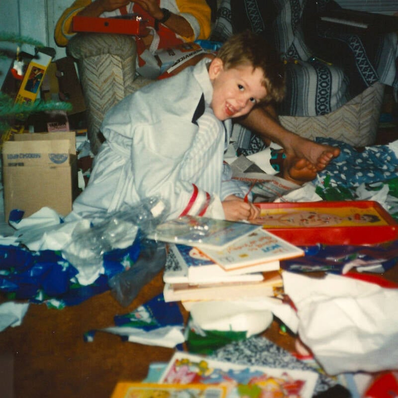 Child Opening Christmas Gifts